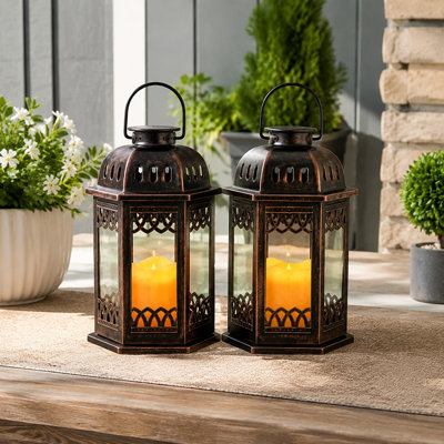 Bronze retro ornate solar lanterns in a 2 Pack feature hanging Handles and Flickering Candle LED light, with each lantern measuring 6.60 x 6.60 x 10.60 in. For outdoor use.