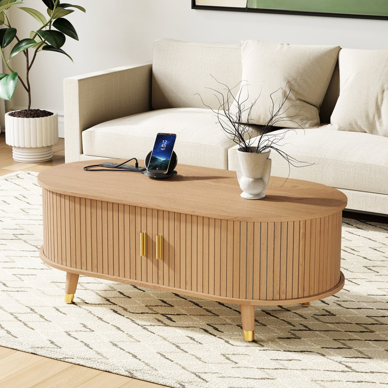 Table basse ovale cannelée avec station de charge, espace de rangement, porte de tambour coulissante et pieds en bois