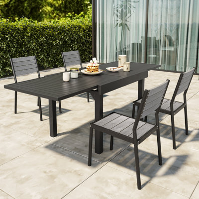Betancur Rectangular 4 - Person Outdoor Dining Set - Extendable Aluminum Table, 4 Armless Chairs