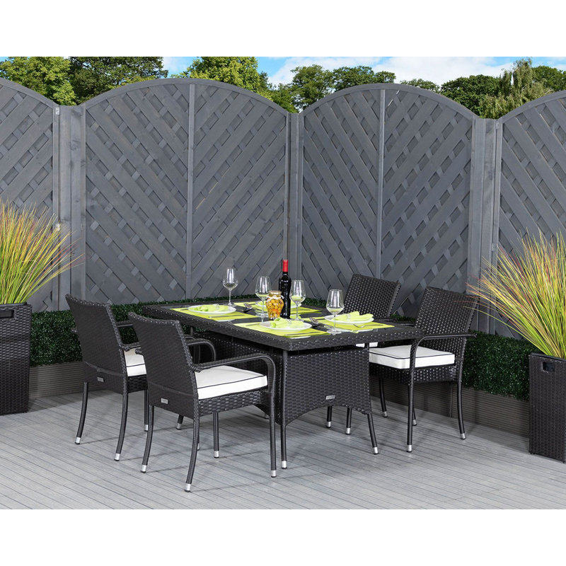 Flaherty 4 - Person Patio Dining Set with Rectangular Table , Cushions Included, Black/Vanilla