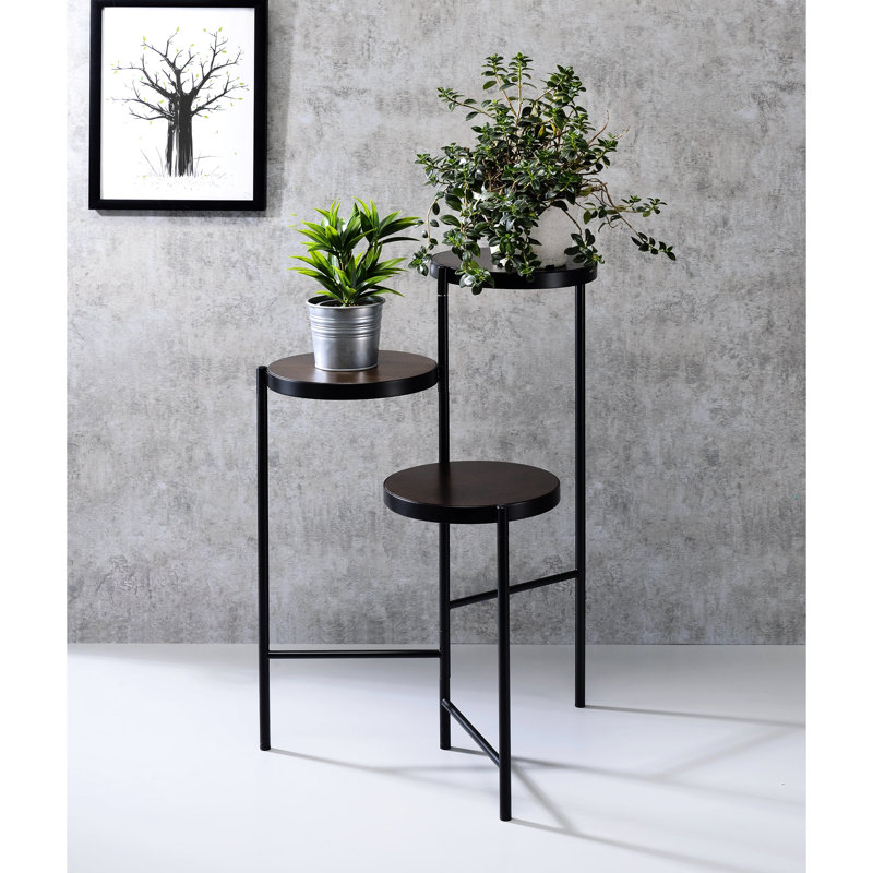 Support à fleurs noir avec 3 compartiments ouverts et une tablette en métal pliable