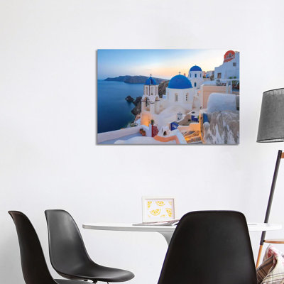 Greece, Santorini, Oia. Sunset On Coastal Town. by Jaynes Gallery - Wrapped Canvas Print