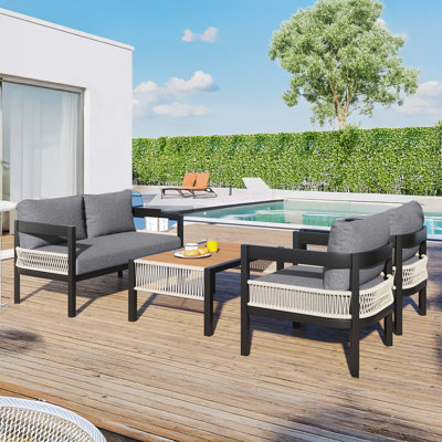 Modern Iron Outdoor Sofa with Sleek Rattan Accents & Matching Table