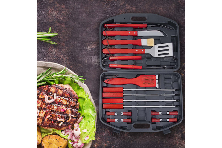 red handled grill tool set with plate of food