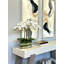Orchids And Leaves Arranged In An Oblong Clear Glass With Moss And Rocks