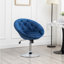 Fauteuil pivotant d'appoint en velours bleu, avec dossier capitonné.