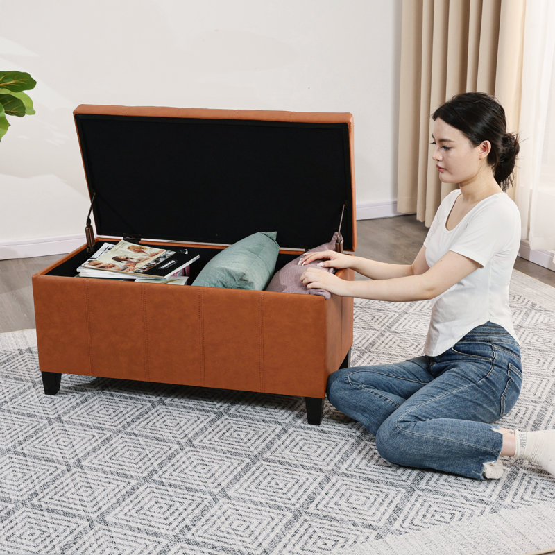 Repose-pieds de rangement en similicuir 33,6 po avec pieds en bois