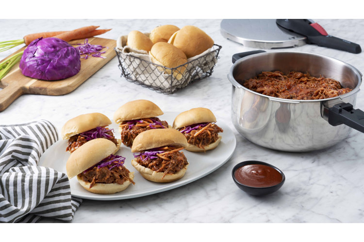 Stovetop pressure cooker serving pulled chicken barbecue burgers.