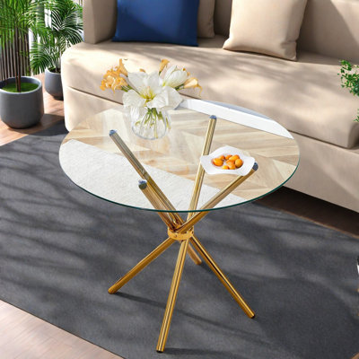 Tables de salle à manger élégantes en verre avec pieds en métal doré pour les maisons modernes
