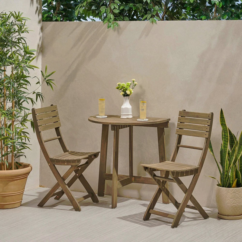 Ensemble bistro 3 pièces d'extérieur pliant en bois d'acacia avec résistance aux intempéries et conception peu encombrante.