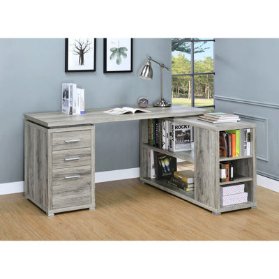 Bureau d'ordinateur en forme de L, style bois flotté gris, élégant et rustique, avec cinq zones de rangement et des étagères aux tons patinés.