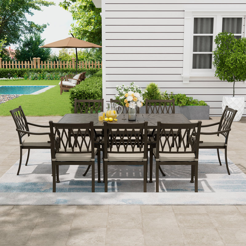 Wike 8 - Person Patio Dining Set Umbrella Hole Included Rectangular Table with Cushions Included, Beige