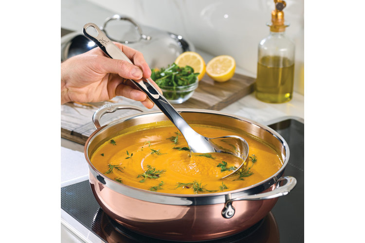 stainless steel ladle being used in a bisque on the stove