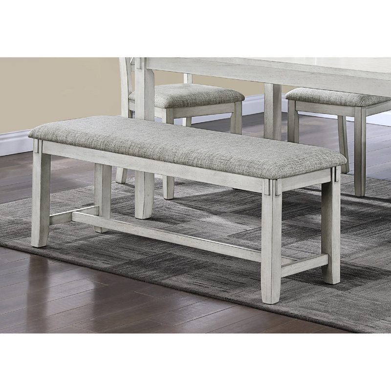 Banc contemporain en bois flotté avec assise rembourrée grise et pieds fuselés pour manger en bois massif dans l'espace