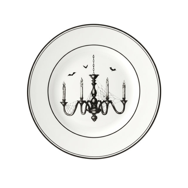 White salad plate with a black rim featuring a spooky, spiderweb-covered chandelier and flying bats in the center.