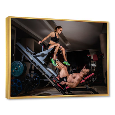" Man Doing Leg Presses With His Trainer "