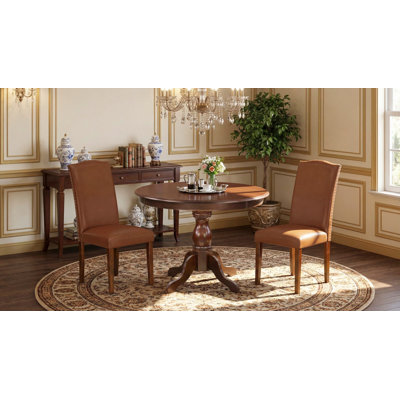 3 Piece Dining Room Table Set Contains a Round Kitchen Table with Pedestal and 2 Brown Faux Leather Parsons Dining Chairs, Mahogany
