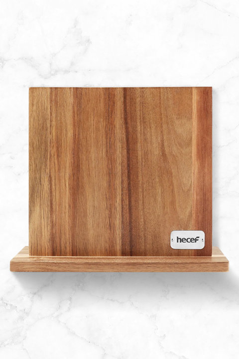Wooden magnetic knife block with Hecef logo on a white marble background.