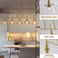 Luminaire suspendu 5 lumières en forme de lustre linéaire doré pour îlot de cuisine avec abat-jour en verre transparent-1285649021-1285649019
