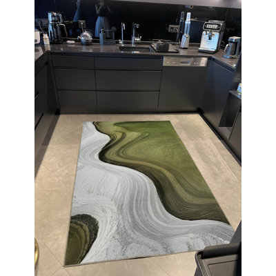 Tapis décoratif gris et vert à motif de vagues surréelles