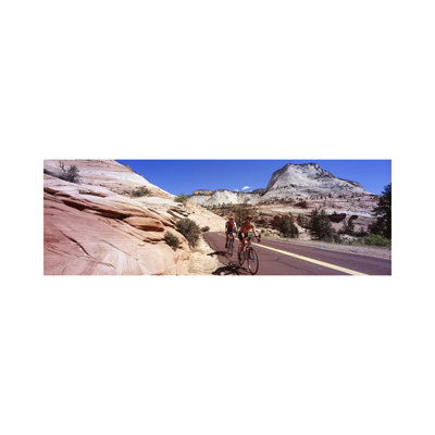 Two People Cycling On The Road, Zion National Park, Utah, USA by Panoramic Images - Wrapped Canvas Panoramic Print