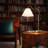 Ornate Brass Ring Base Curved Table Lamp with Triangle White Drum Shade