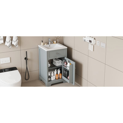 Meuble-lavabo de salle de bain de 20 pouces en noir, lavabo en céramique blanche, design moderne, installation autoportante, finition peinte, porte à fermeture douce et tablette réglable.