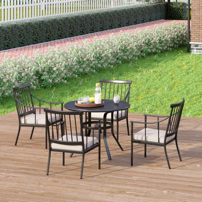 Argyri 4 - Person Patio Dining Set with Round Table , Cushions Included