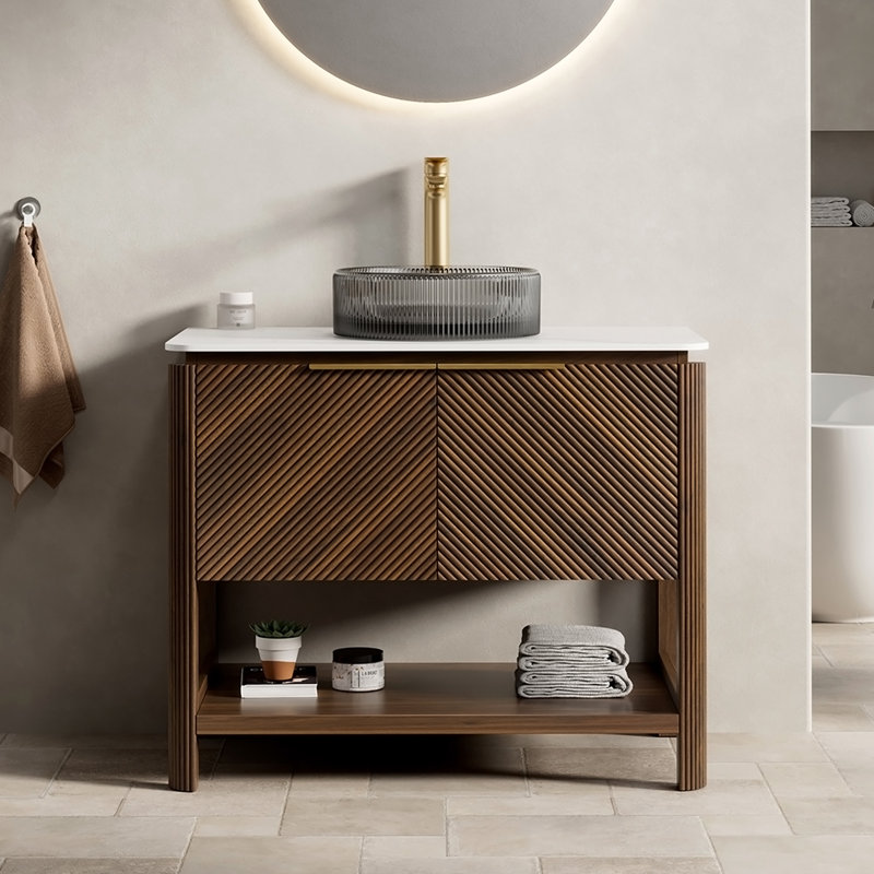 Meuble-lavabo autoportant avec comptoir en pierre frittée, vasque, armoire en contreplaqué, portes cannelées en diagonale, tablette ouverte et quincaillerie à fermeture en douceur.