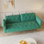 Luxueux canapé-lit en velours vert avec garniture cloutée et coussin décoratif assorti, pour plus de confort et de style-169636619