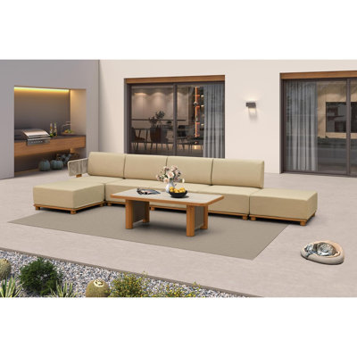 Ensemble de mobilier de jardin en forme de L comprenant un canapé 7 pièces, 2 poufs et 1 table.