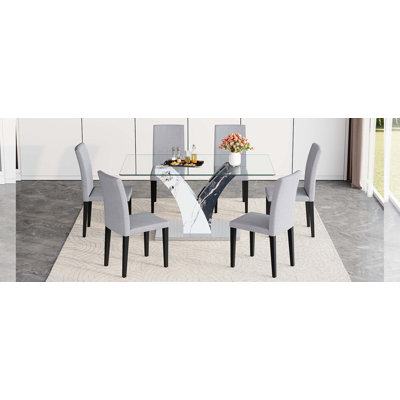 Ensemble de table et de chaises. Table de salle à manger moderne, comptoir en verre trempé et pieds en panneau de fibres à densité moyenne artistique.