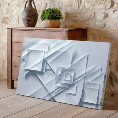 La toile crée une composition abstraite mettant en vedette une série de formes d'art géométriques se chevauchant dans différentes nuances de blanc et d'art mural sur toile