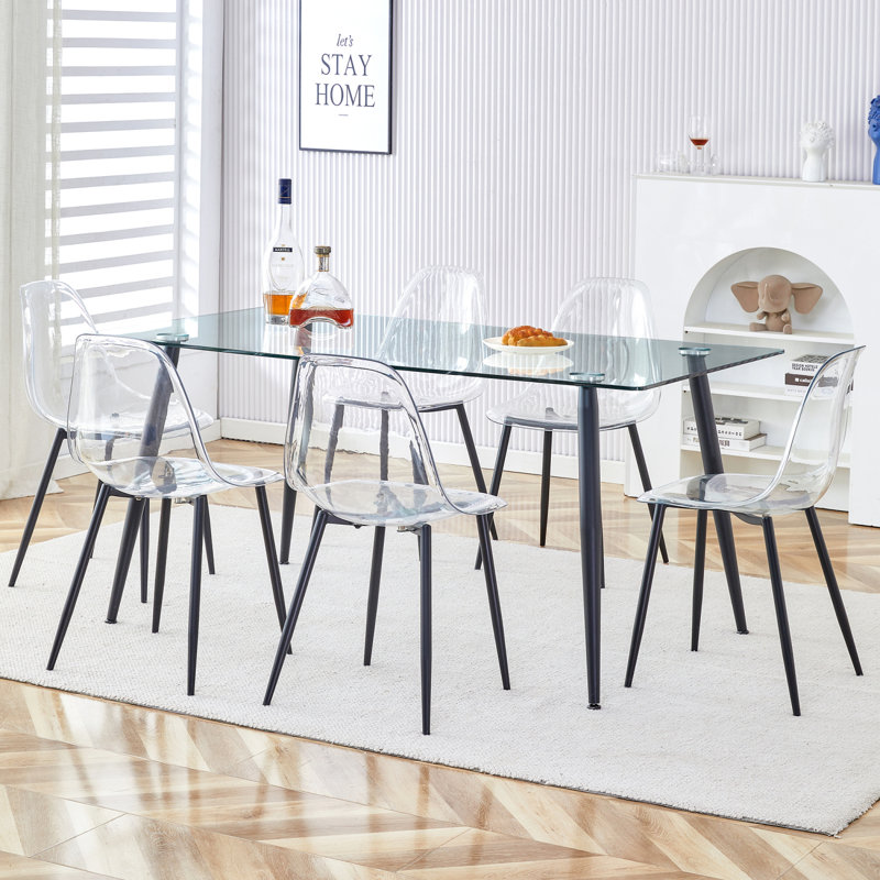 1 table et 6 chaises. Table rectangulaire, plateau de table en verre trempé transparent et pieds de table en métal noir. Jumelé avec 6 chaises à pieds en métal noir. DT-1544 TW-1200