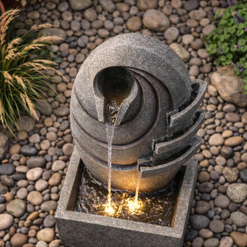 Fontaine moderne d'extérieur ovale avec éclairage DEL, débit réglable et conception en polyrésine résistante aux intempéries