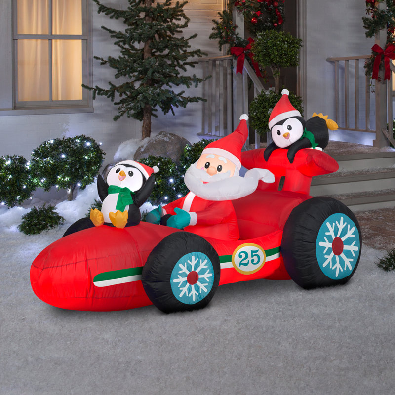 Père Noël en voiture de course gonflable