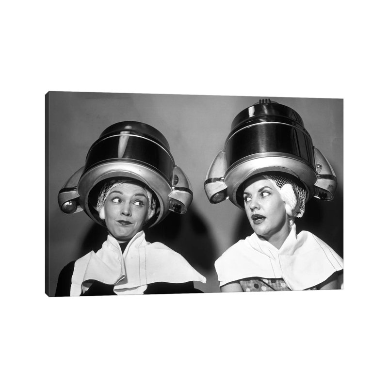 1950s Two Women Sitting Together Gossiping Under Hairdresser Hair Dryer by Vintage Images - Wrapped Canvas Print