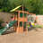 Treasure Cove Wooden Swing Set with Slides and Rock Wall