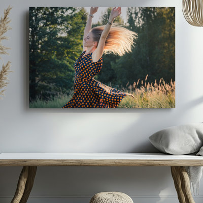Canvas A Joyful Woman With Long Flowing Blonde Hair Twirls Exuberantly Wall Art In A Sunlit Field Her Arms Raised High Exuding Freedom Canvas Wall Art