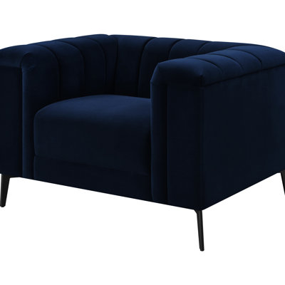 Fauteuil surdimensionné bleu avec accoudoirs plissés, ressorts ensachés et pieds tournés à finition brune pour un salon douillet et relaxant