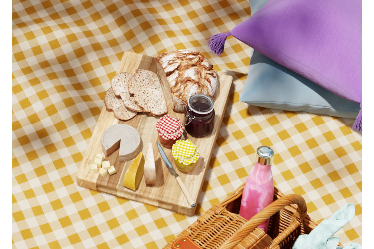 outdoor picnic with a 'girl dinner' spread of bread, cheese, and jam