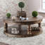 Table basse ronde en bois de style rustique avec finition gris antique, pieds tournés et tablette ouverte pour un rangement élégant