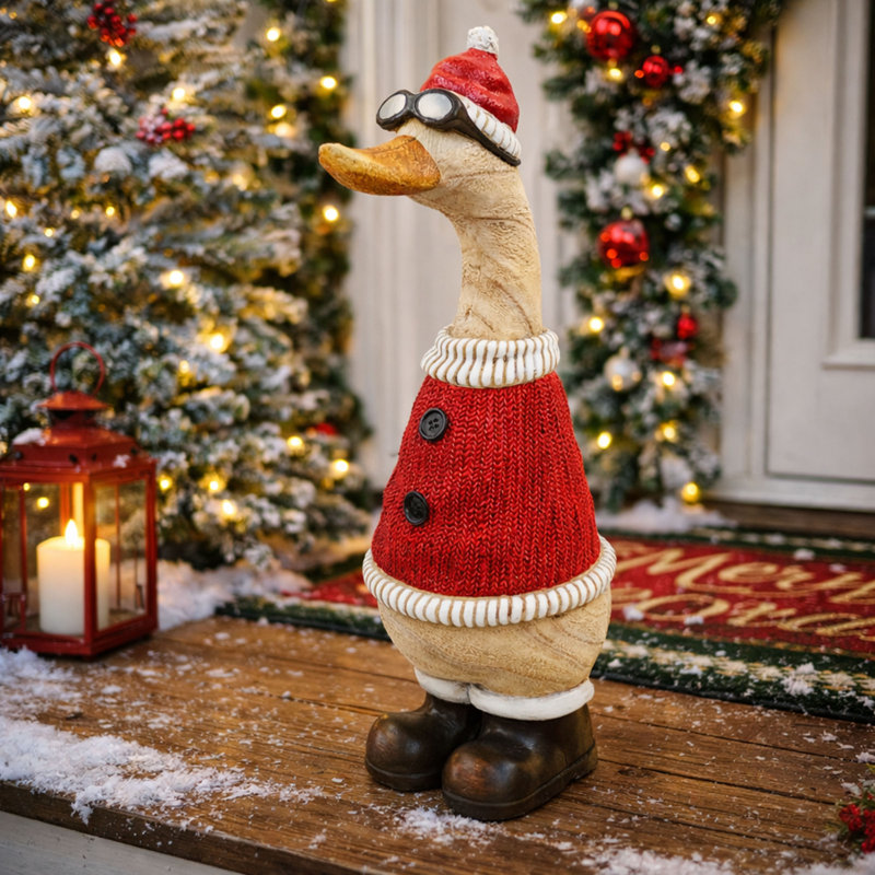 Noël canard de Noël en chandail rouge et chapeau statuaire