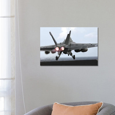 An F/A-18E Super Hornet Launches Off The Flight Deck Of USS Kitty Hawk by Stocktrek Images - Wrapped Canvas Print