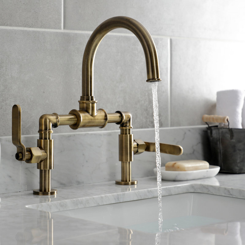 Kingston Brass Whitaker Two-Handle 2-Hole Deck Mount Bridge Bathroom Faucet with Pop-Up Drain, Antique Brass