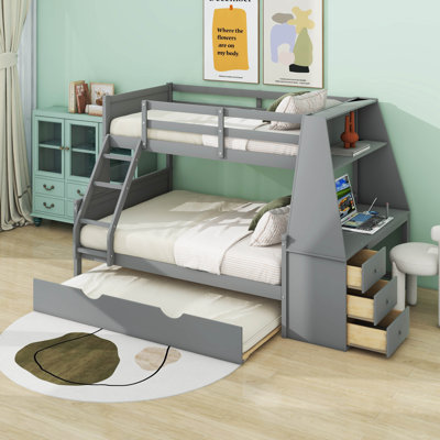 Lit simple superposé au dessus d'un lit double avec bureau, tiroirs et tablettes