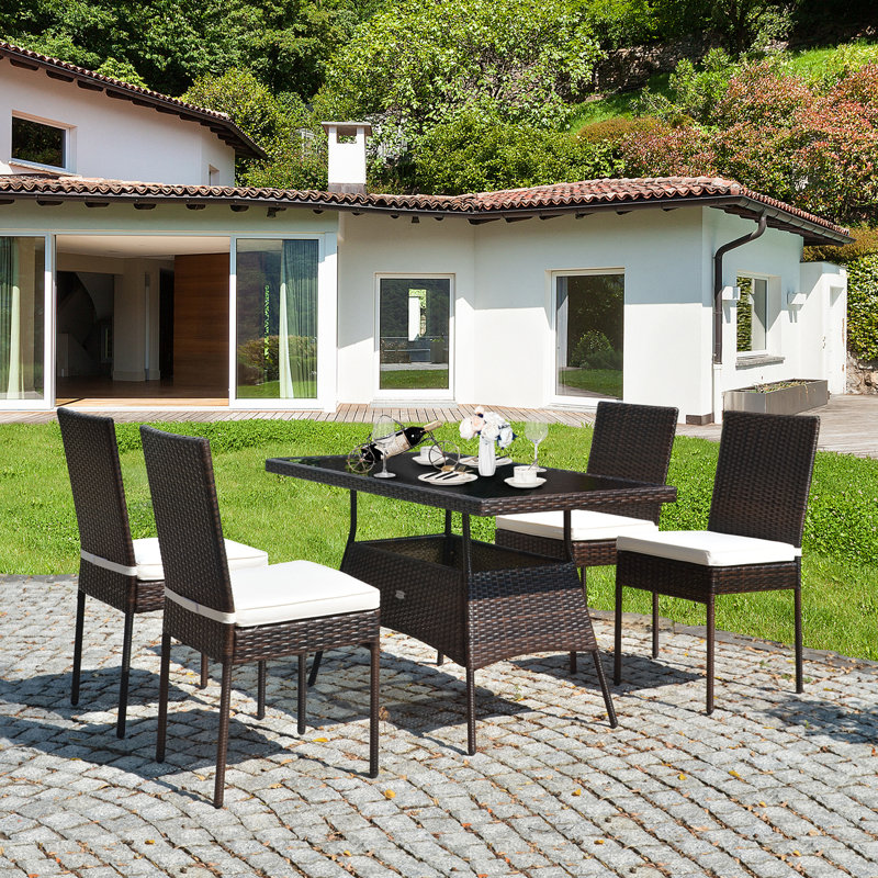 Ladera 4 - Person Wicker Patio Dining Set with Rectangular Table , Cushions Included, Brown
