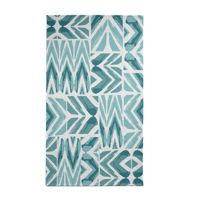 Tapis bleu sarcelle à motif géométrique