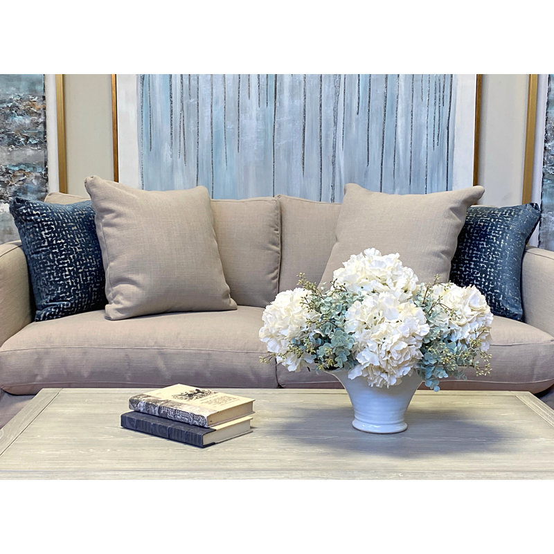 Hydrangea And Seeded Eucalyptus Floral Arrangement In A Round Ceramic Vase