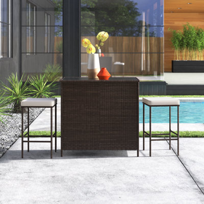 Avacyn 3 Piece Seating Group with CushionsHeight Table with Glass Table Top Storage Shelves 2 Bar Stools